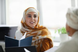 One woman talking to another, offering support and connection.